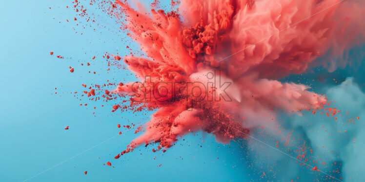 An explosion of red colored dust on a blue background - Starpik Stock