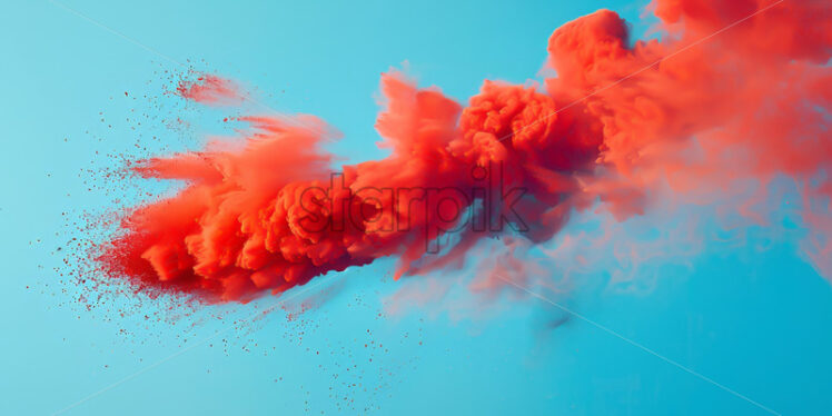 An explosion of red colored dust on a blue background - Starpik Stock