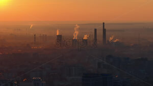 Aerial drone view of thermal power stations in Bucharest at sunset. Flying birds. Romania - Starpik Stock