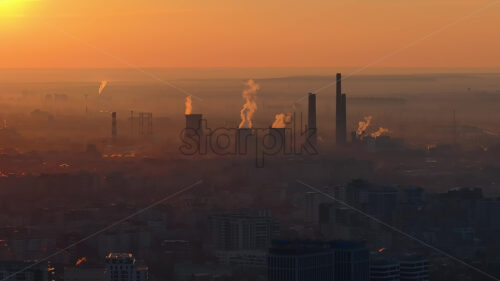 Aerial drone view of thermal power stations in Bucharest at sunset. Flying birds. Romania - Starpik Stock