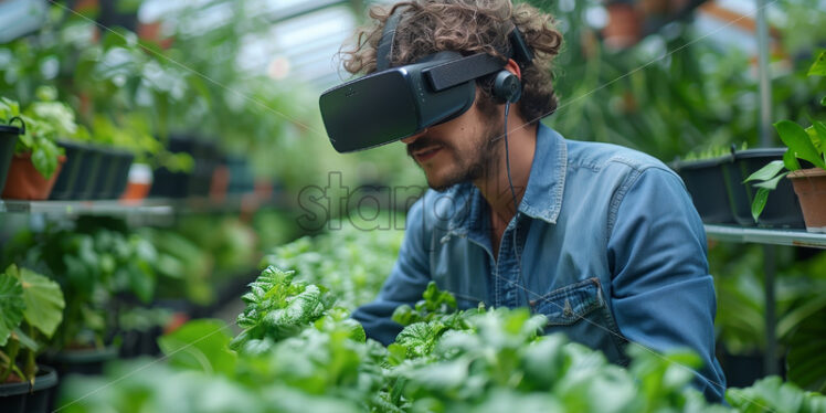 Man cultivator using VR glasses in a greenery full with plants - Starpik