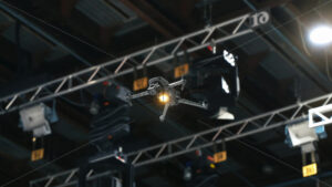VIDEO Drone flying and filming near flashing studio lights and camera equipment on a TV set - Starpik