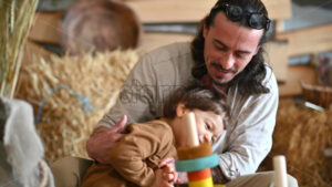 VIDEO Father playing with his son in a barn, near square hay bales - Starpik