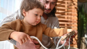 VIDEO Father playing with his son with ecological wooden toys near the window - Starpik