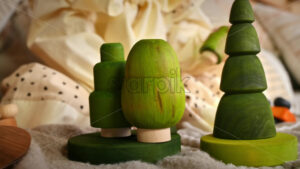 VIDEO Little girl playing with several green wooden tree toys. Ecological and sustainability concept - Starpik