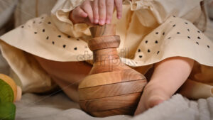 VIDEO Little girl’s hands playing with a wooden stacking jug. Ecological and sustainability concept - Starpik