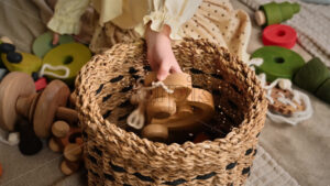 VIDEO Little girl’s hands put wooden toys in the basket. Ecological and sustainability concept - Starpik