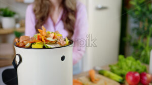 VIDEO Woman recycling organic waste by composting vegetables peels in the Bokashi in the kitchen - Starpik