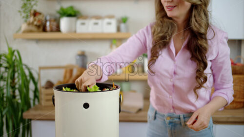 VIDEO Woman recycling organic waste by composting vegetables peels in the Bokashi in the kitchen - Starpik