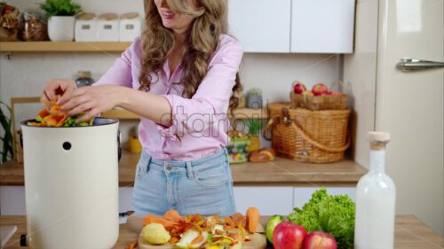 VIDEO Woman recycling organic waste by composting vegetables peels in the Bokashi in the kitchen - Starpik