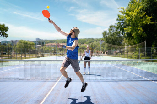 Couple playing pickleball outdoor at daylight - Starpik