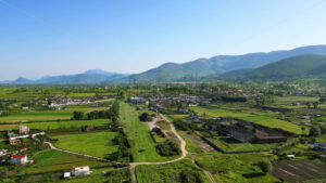 VIDEO Aerial, drone view of a village in Albania, with mountains on the background - Starpik