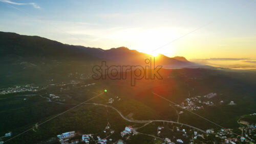 VIDEO Aerial, drone view of buildings on the shore of the Adriatic sea, with mountains on the background in Montenegro - Starpik