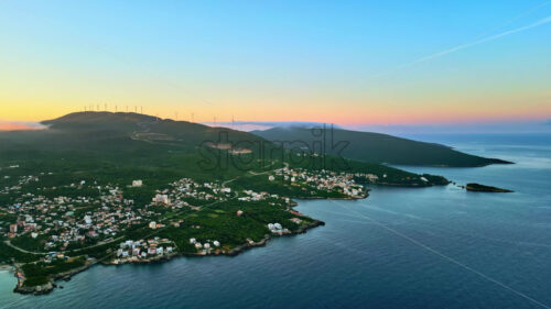 VIDEO Aerial, drone view of buildings on the shore of the Adriatic sea, with mountains on the background in Montenegro - Starpik