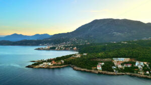 VIDEO Aerial, drone view of buildings on the shore of the Adriatic sea, with mountains on the background in Montenegro - Starpik