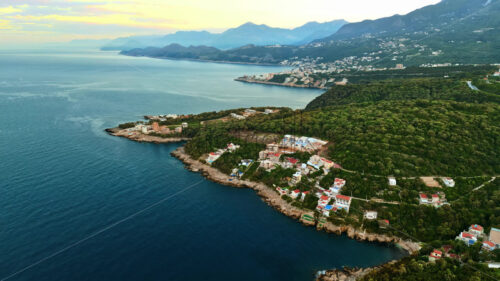 VIDEO Aerial, drone view of buildings on the shore of the Adriatic sea, with mountains on the background in Montenegro - Starpik