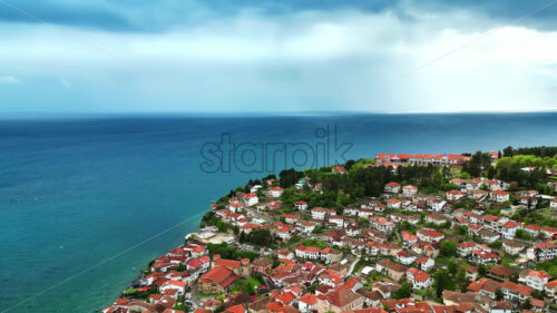 VIDEO Aerial, drone view of houses on the shore of the Aegean Sea in North Macedonia - Starpik