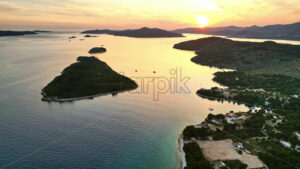 VIDEO Aerial, drone view of land on the shore of the Adriatic sea in Croatia, at sunset - Starpik