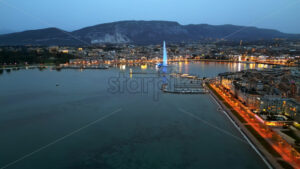 VIDEO Aerial, drone view of the Geneva Water Fountain in Switzerland in the evening - Starpik