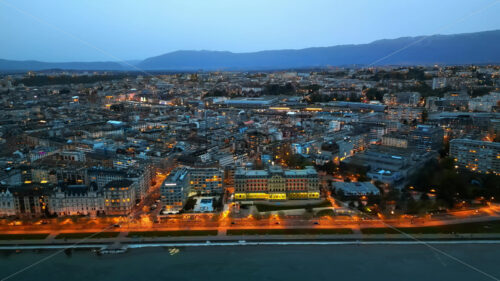 VIDEO Aerial, drone view of the streets and buildings of Geneva, Switzerland in the evening - Starpik