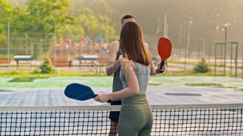 VIDEO Man and woman doing a secret handshake after playing pickleball after rain - Starpik