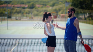 VIDEO Man and woman wearing sunglasses doing a secret handshake after playing pickleball - Starpik