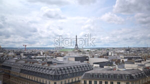 VIDEO Paris, France – June 18, 2024: Distant view of the Eiffel Tower with buildings surrounding it in Paris, France - Starpik