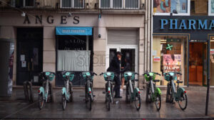 VIDEO Paris, France – June 18, 2024: Green and turquoise electric bikes parked on the street - Starpik