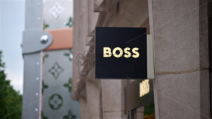 VIDEO Paris, France – June 18, 2024: Sign of the Hugo Boss store with the Louis Vuitton store on the background - Starpik