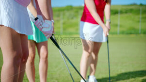 VIDEO Three women with golf clubs in their practicing on a course - Starpik