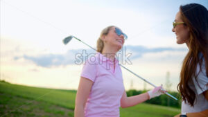 VIDEO Two woman holding golf clubs and high fiving each other on a sunny day - Starpik