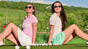 VIDEO Two women standing on the golf course near a bucket with balls - Starpik