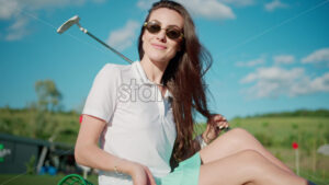 VIDEO Woman playing with a golf ball standing on the course near a bucket - Starpik