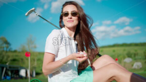 VIDEO Woman playing with a golf ball standing on the course near a bucket - Starpik