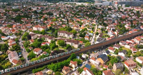 VIDEO Aerial drone view of Neuilly-Plaisance commune with regional express train in the eastern suburbs of Paris, France - Starpik