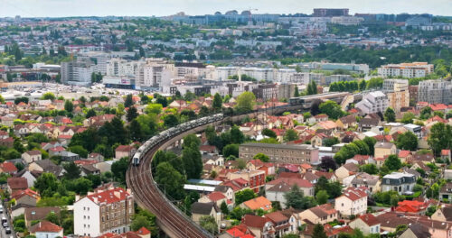 VIDEO Aerial drone view of Neuilly-Plaisance commune with regional express train in the eastern suburbs of Paris, France - Starpik