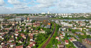 VIDEO Aerial drone view of Neuilly-Plaisance commune with regional express train in the eastern suburbs of Paris, France - Starpik