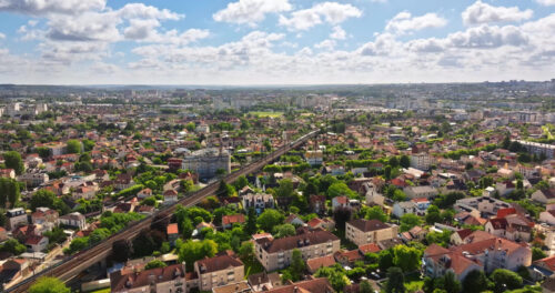 VIDEO Aerial drone view of Neuilly-Plaisance commune with regional express train in the eastern suburbs of Paris, France - Starpik