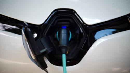 VIDEO Close up of a white electric car charging - Starpik