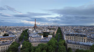 VIDEO Distant view of the Eiffel Tower sparkling in the evening with buildings surrounding it in Paris, France - Starpik