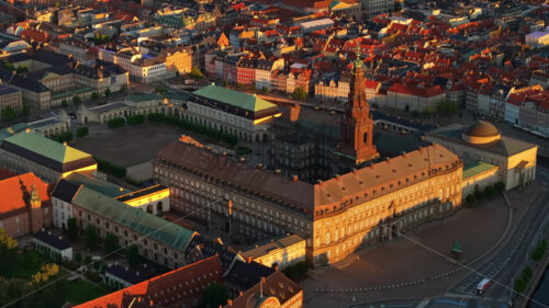 VIDEO – Aerial drone view of the Christiansborg Palace on the islet of Slotsholmen in central Copenhagen, Denmark at sunset - Starpik