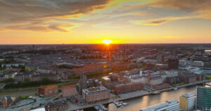 VIDEO Aerial drone view of Nordhavn harbour area at the coast of the Oresund at sunset - Starpik