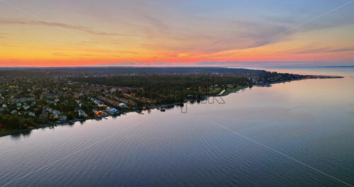 VIDEO Aerial drone view of Osterbo Nord, Nordhavn harbour area at the coast of the Oresund at sunset - Starpik