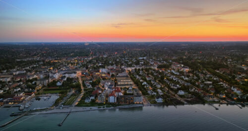 VIDEO Aerial drone view of Osterbo Nord, Nordhavn harbour area at the coast of the Oresund at sunset - Starpik