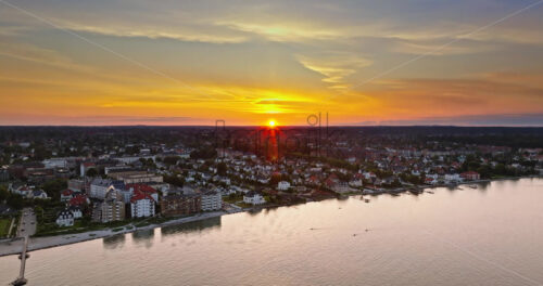 VIDEO Aerial drone view of Osterbo Nord, Nordhavn harbour area at the coast of the Oresund at sunset - Starpik