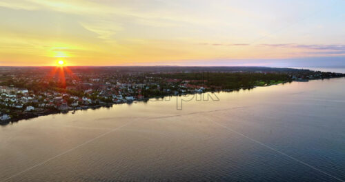 VIDEO Aerial drone view of Osterbo Nord, Nordhavn harbour area at the coast of the Oresund at sunset - Starpik