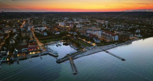 VIDEO Aerial drone view of Osterbo Nord, Nordhavn harbour area at the coast of the Oresund in the evening - Starpik