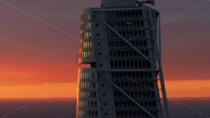 VIDEO Aerial drone view of Turning Torso residential skyscraper in Malmo, Sweden at sunset - Starpik