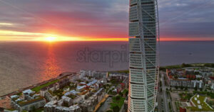 VIDEO Aerial drone view of Turning Torso residential skyscraper in Malmo, Sweden at sunset - Starpik