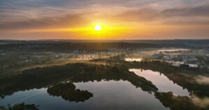 VIDEO Aerial drone view of a lake surrounded by trees in Chisinau, Moldova at sunrise - Starpik